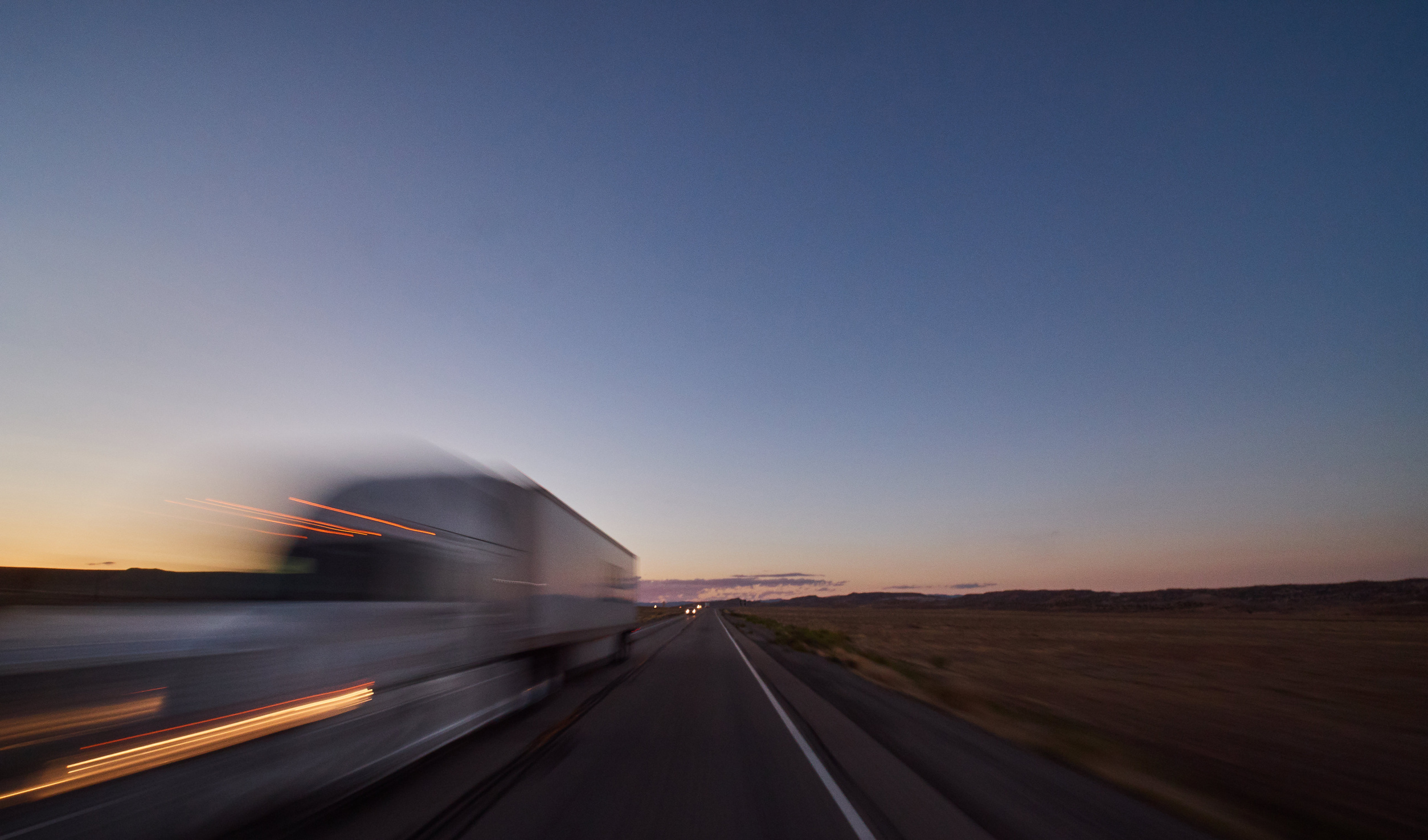 Freight lorry on the motorway at dusk