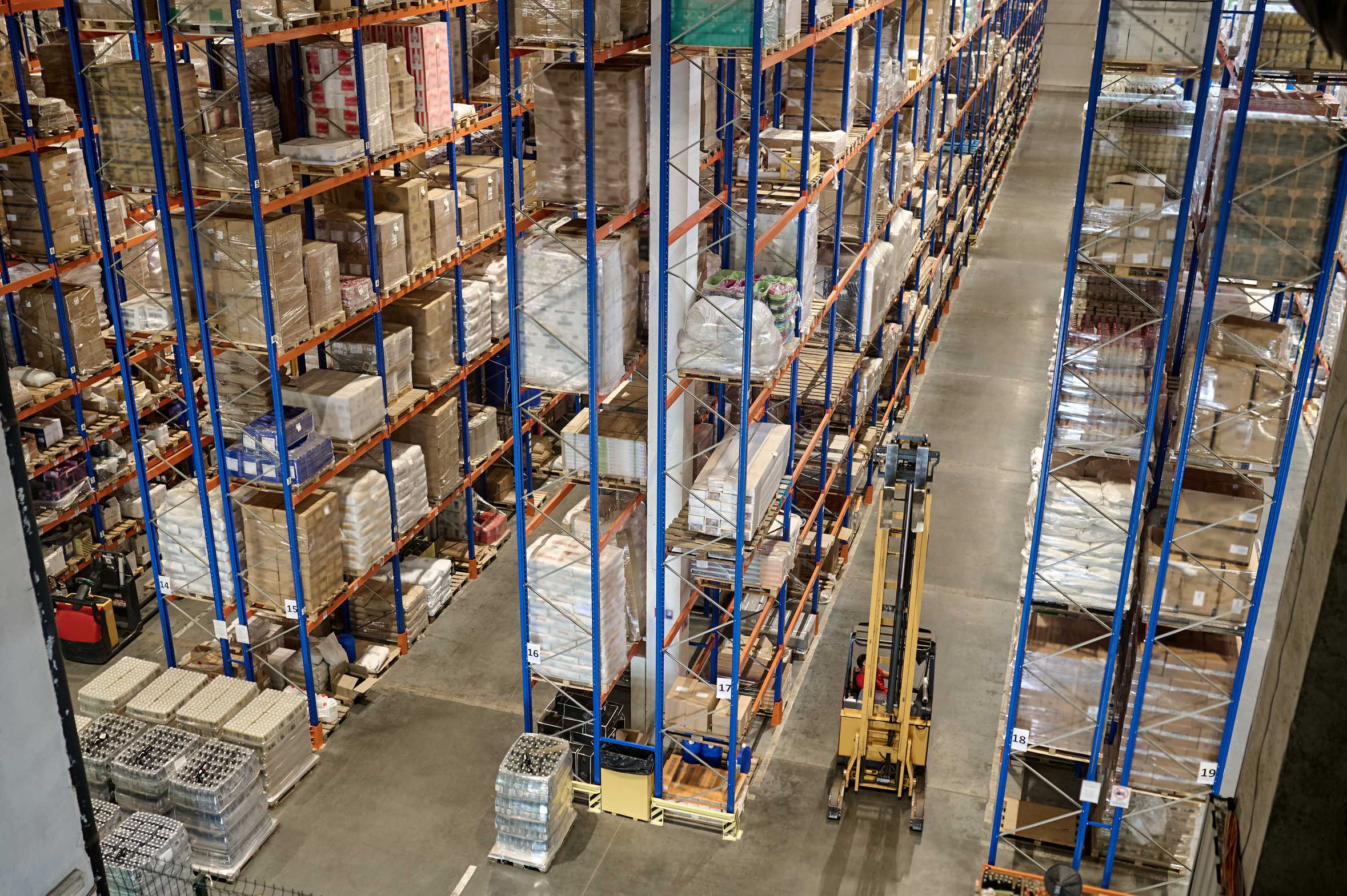 Forklift working the aisles of a distribution warehouse