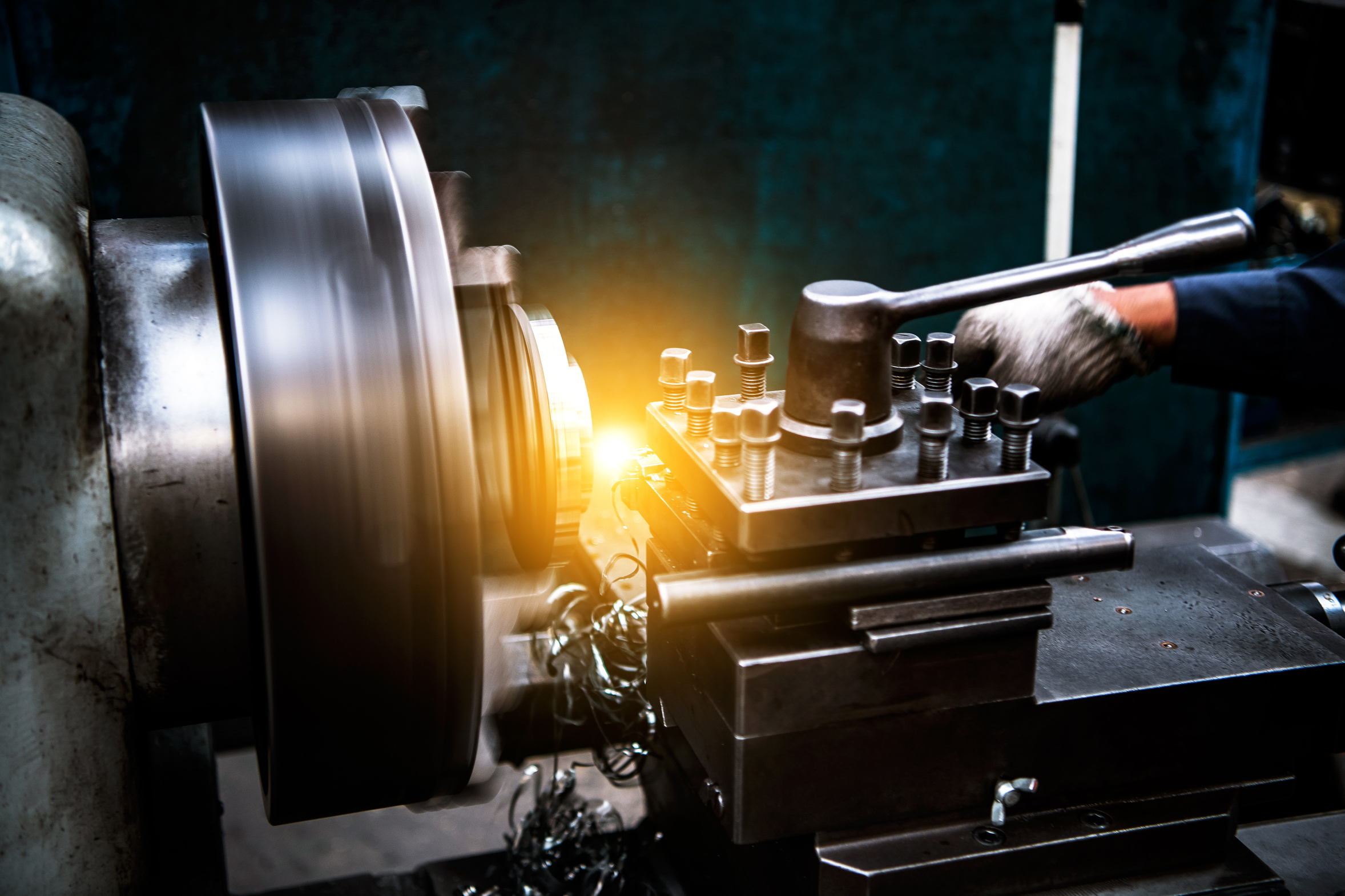 Lathe turning a metal component in a workshop