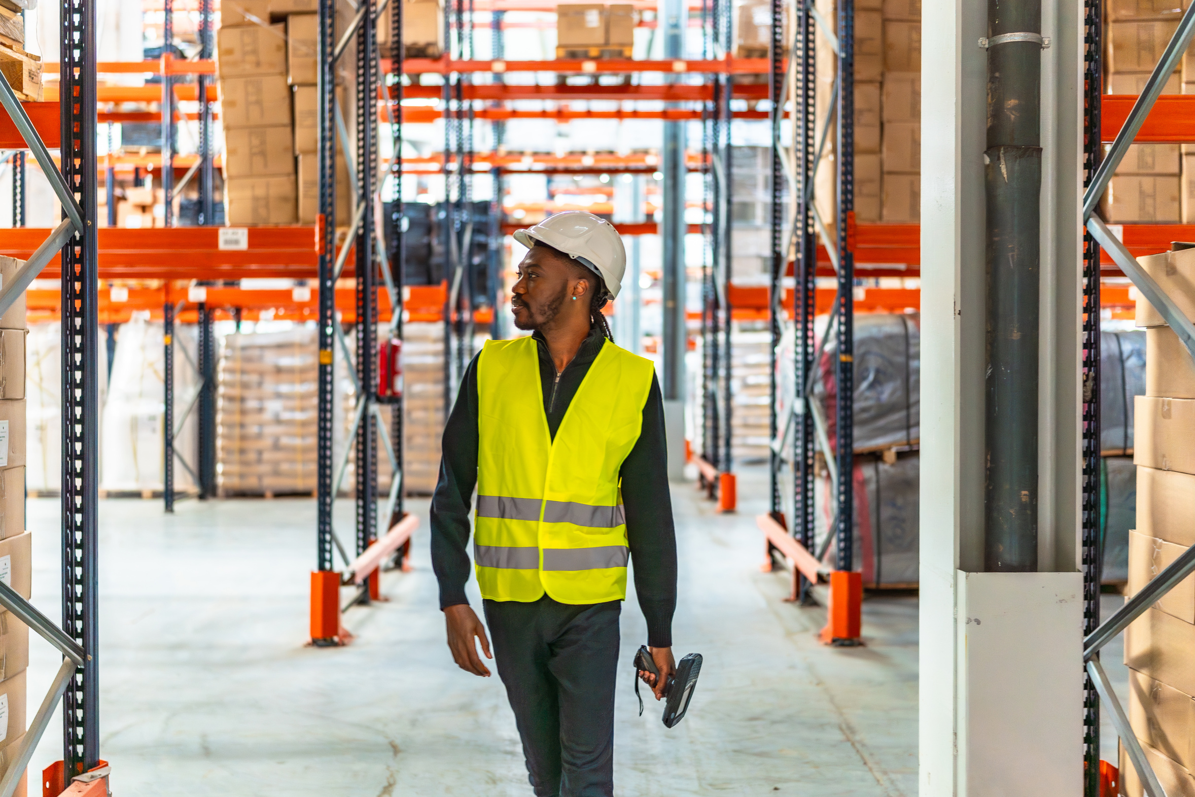 Warehouse operative scanning stock between the racks