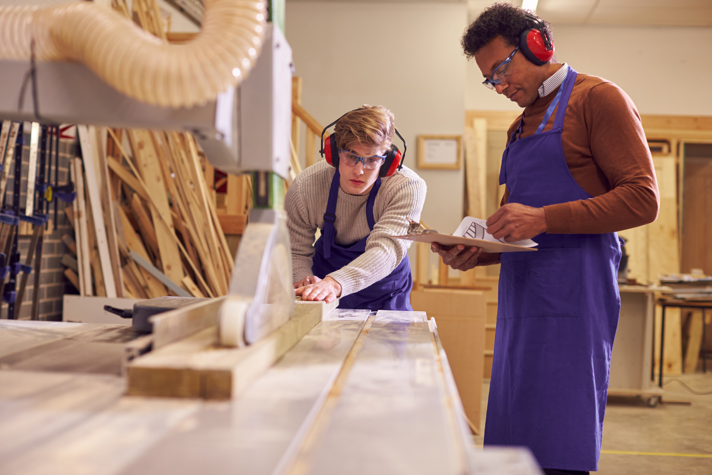 Experienced joiner working alongside an apprentice