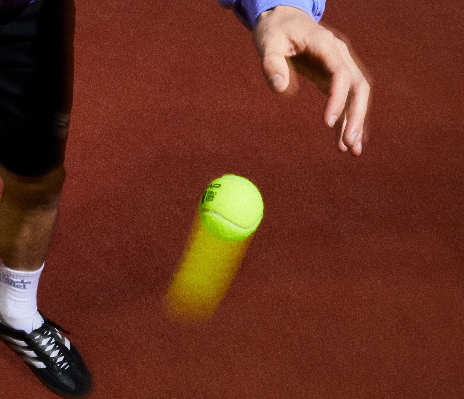 A padel ball in play on the distinctive red courts at Club de Padel Sheffield