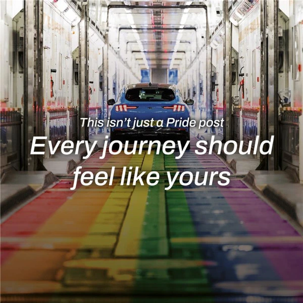 Example of our social media content - Image shows a blue car driving through a tunnel with a rainbow-colored floor and text overlay reading 'This isn’t just a Pride post Every journey should feel like yours.'