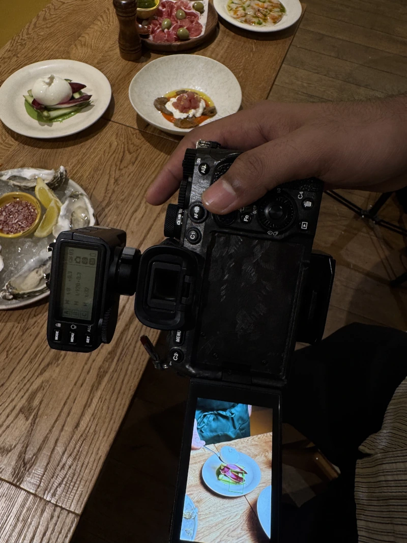 A video camera recording a plated appetiser, illustrating the practical application of Kith&Kind’s media training service to equip spokespeople for interviews and protect the organisation’s reputation during high-profile coverage