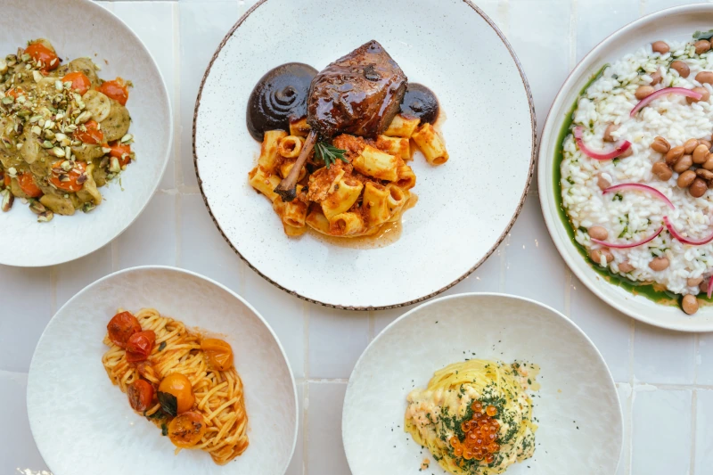 Five plates of beautifully plated, high-quality restaurant food, representing the culinary excellence that maximises a client’s chances of winning prestigious industry awards and guaranteeing the brand gets the industry spotlight it deserves.