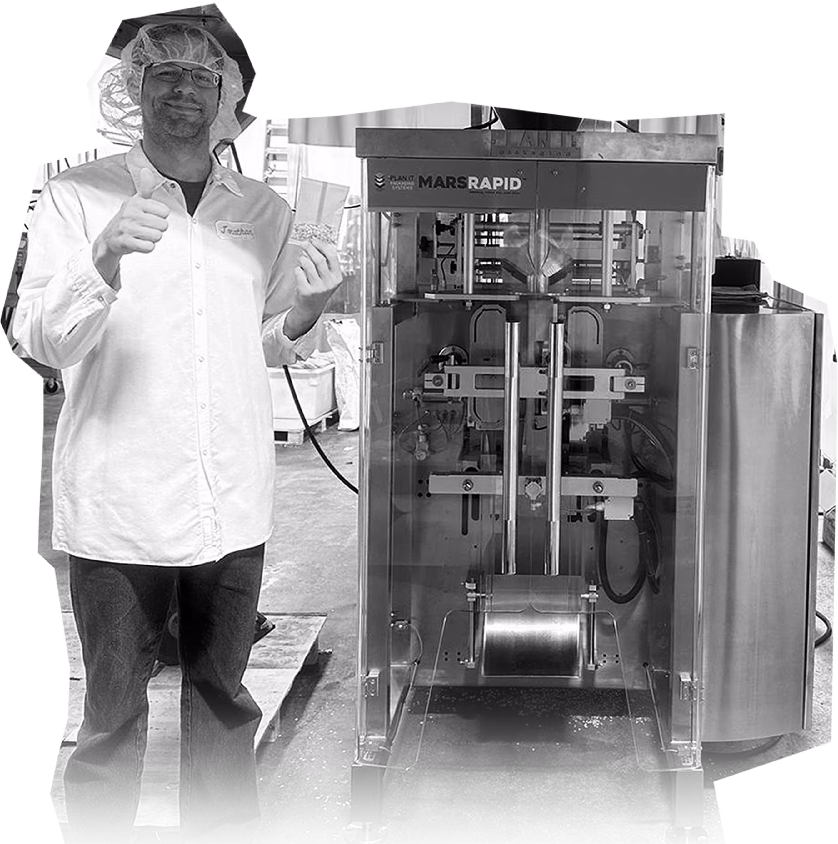 Man in a hairnet and glasses giving thumbs up while holding a plastic bag of grains next to a Mars Rapid packaging machine.