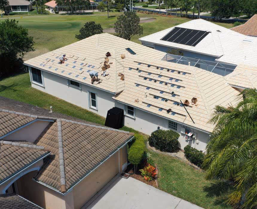 BeeGreen Roofing crew reinstalling solar panels after new roof installation in New Port Richey, FL
