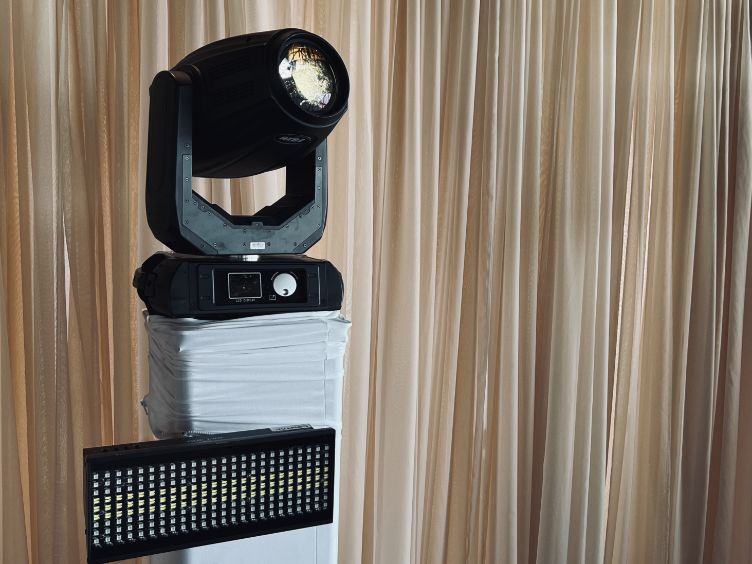 LED strobe and moving light on truss tower with scrim in front of sheer curtain backdrop from Contak AV’s Montreal rental inventory