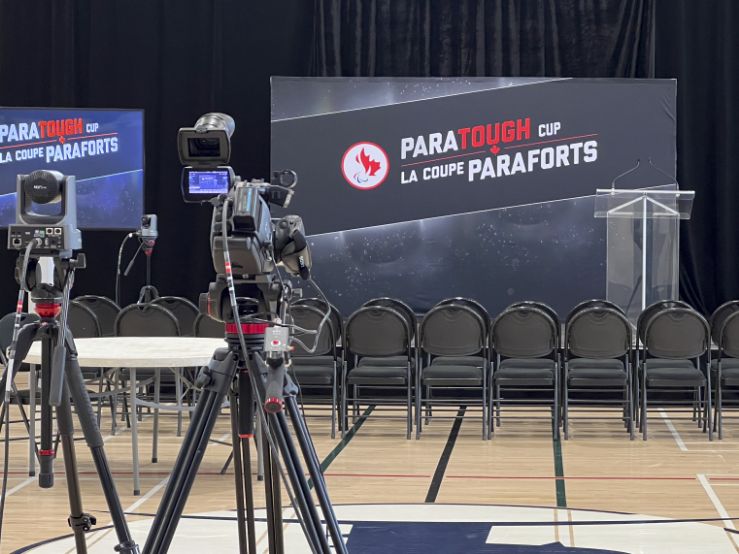 AV setup at Paratough Cup Montreal with stage lectern, broadcast cameras, and large TV display for live event production