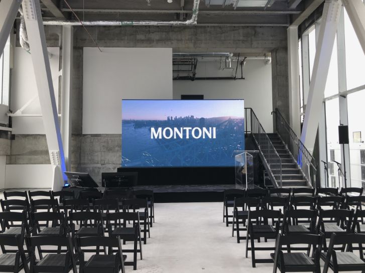 Professional audiovisual setup for corporate event with LED screen, transparent podium, and modern architecture - Montoni event in Montreal