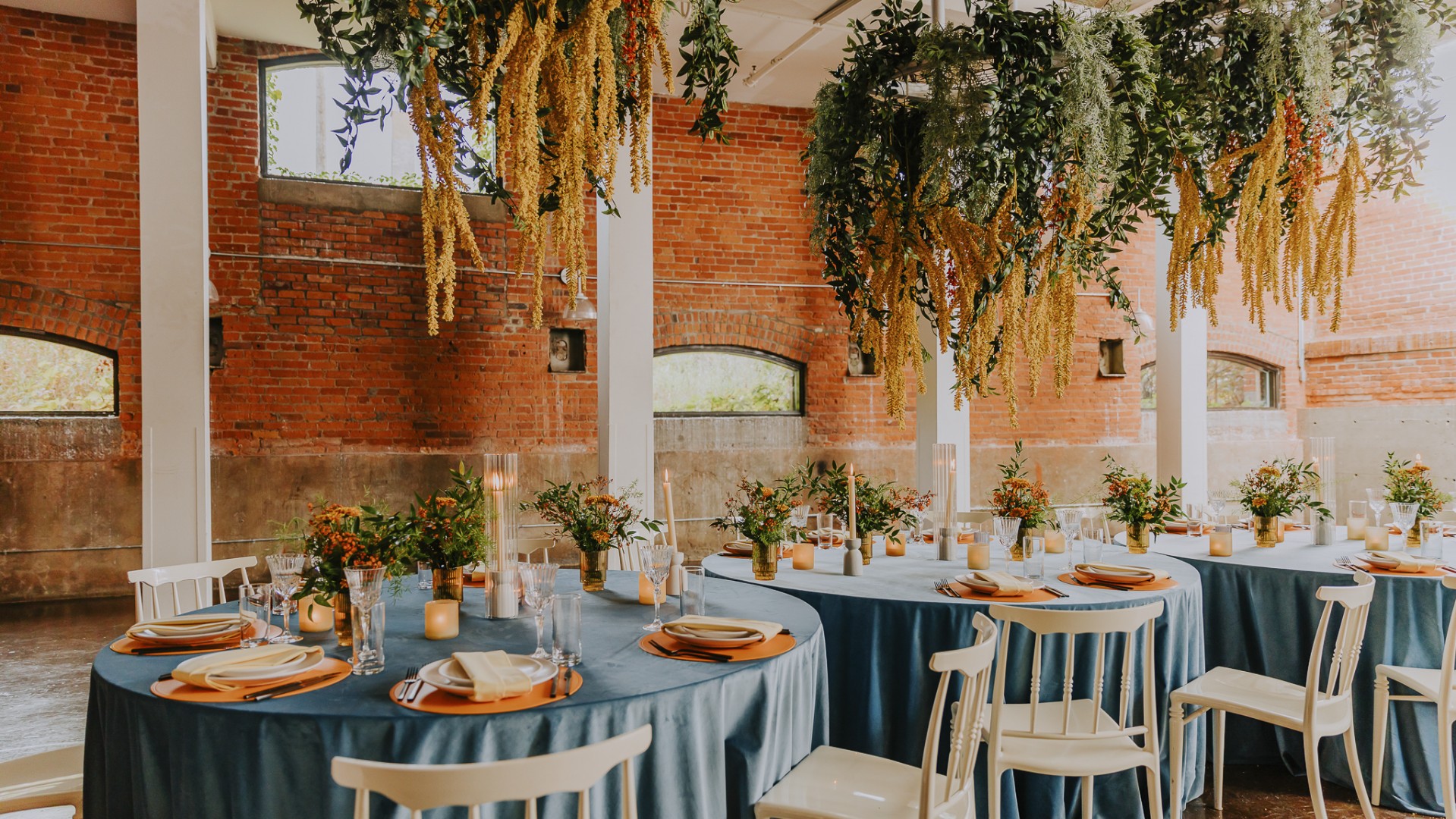 Unique suspended floral installations for a luxury Montreal wedding at Entrepôts Dominion, with atmospheric plant chandeliers over reception tables