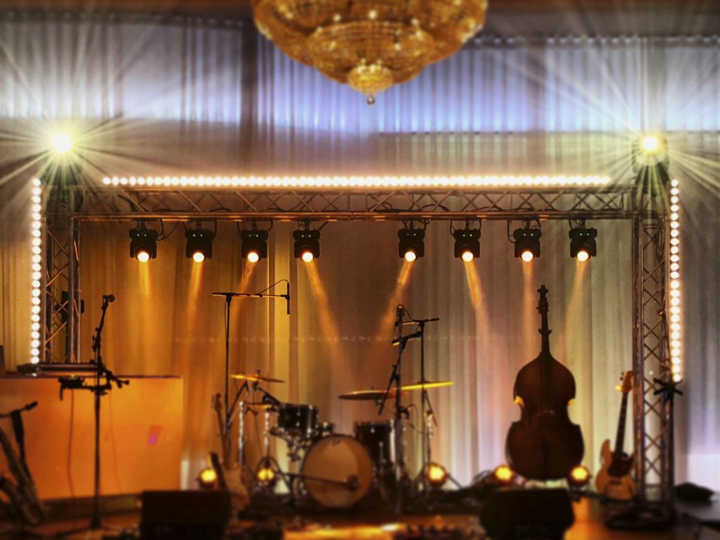 Stage design with truss arch, moving head lights, and LED pixel mapping for live jazz band performance in Montreal