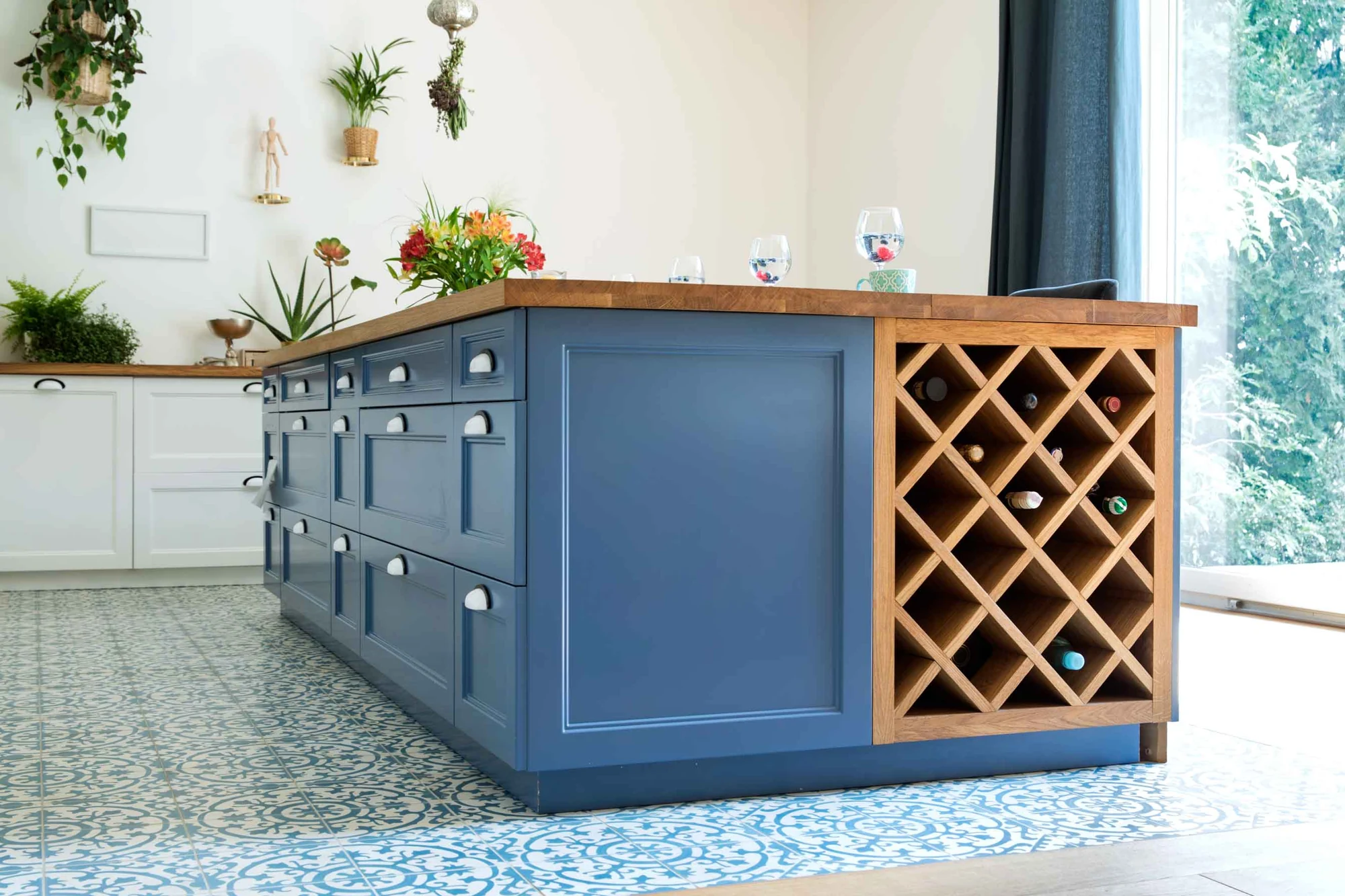 Custom blue cabinetry with integrated wine storage and tailored island details