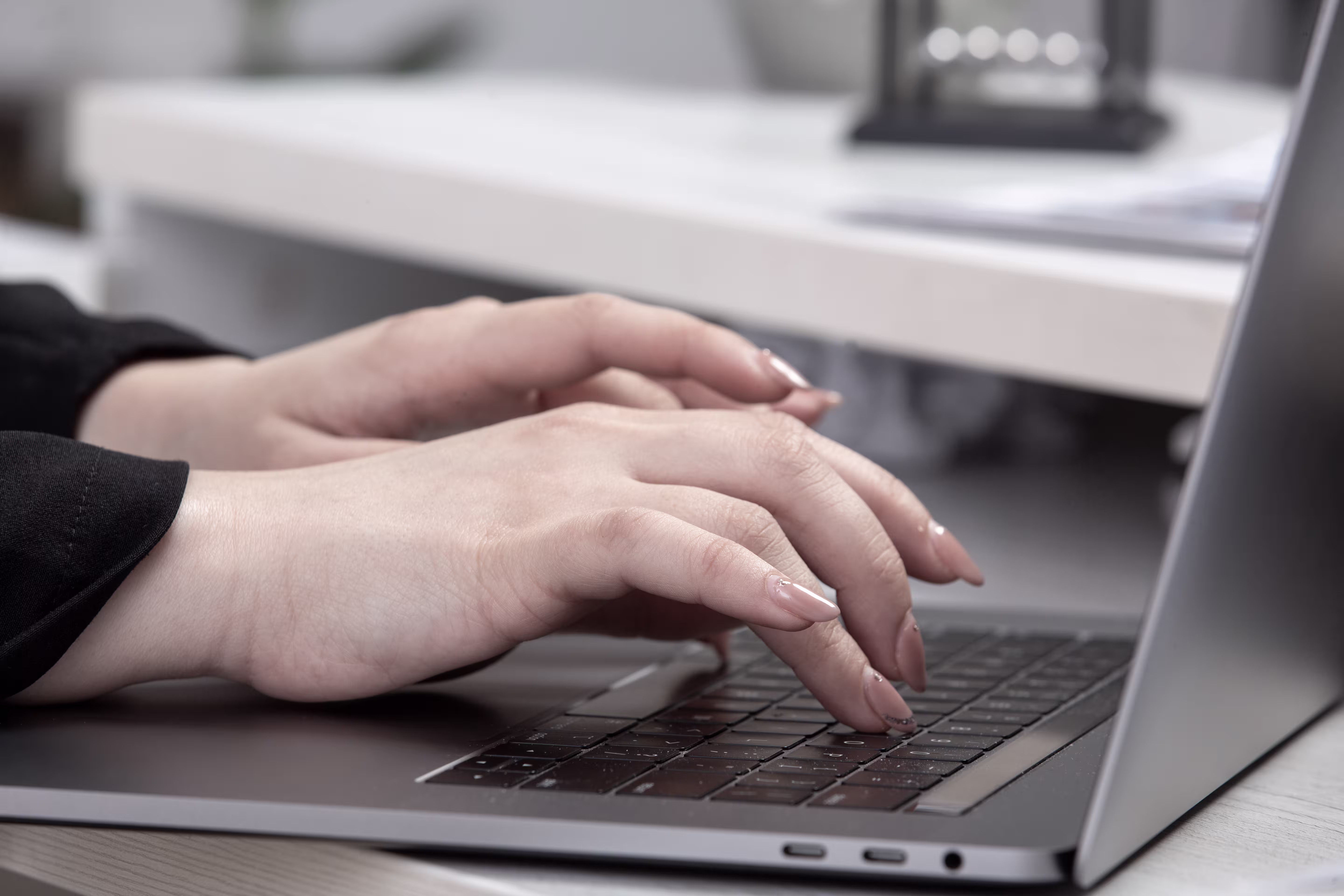 Person typing on laptop illustrating AI assistant powered by large language models