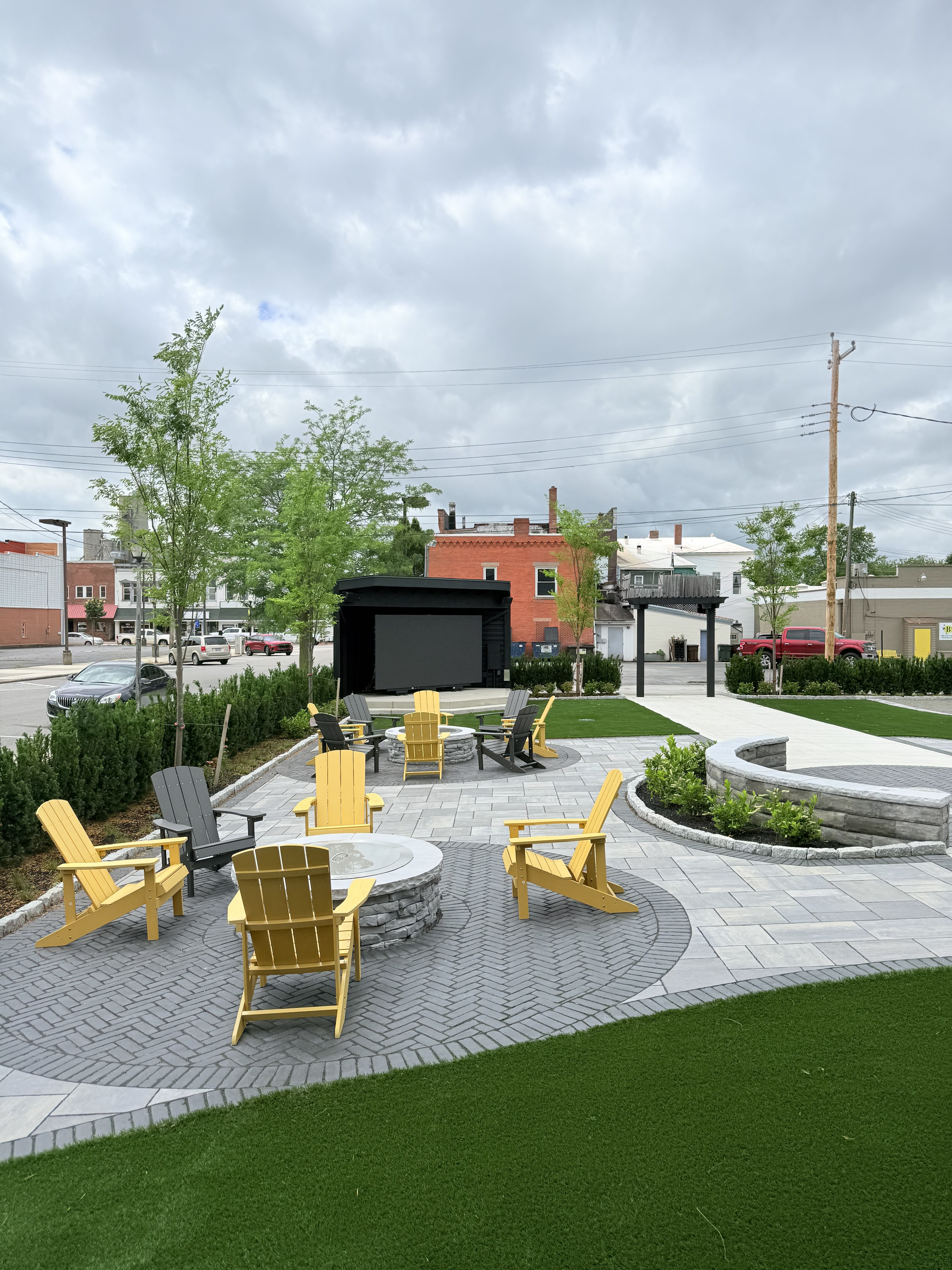 Outdoor beer garden at Old Route 69 Brewery in Ada, Ohio, featuring spacious seating, lawn games, and a large 140-inch LED jumbotron for live sports, movies, and entertainment.