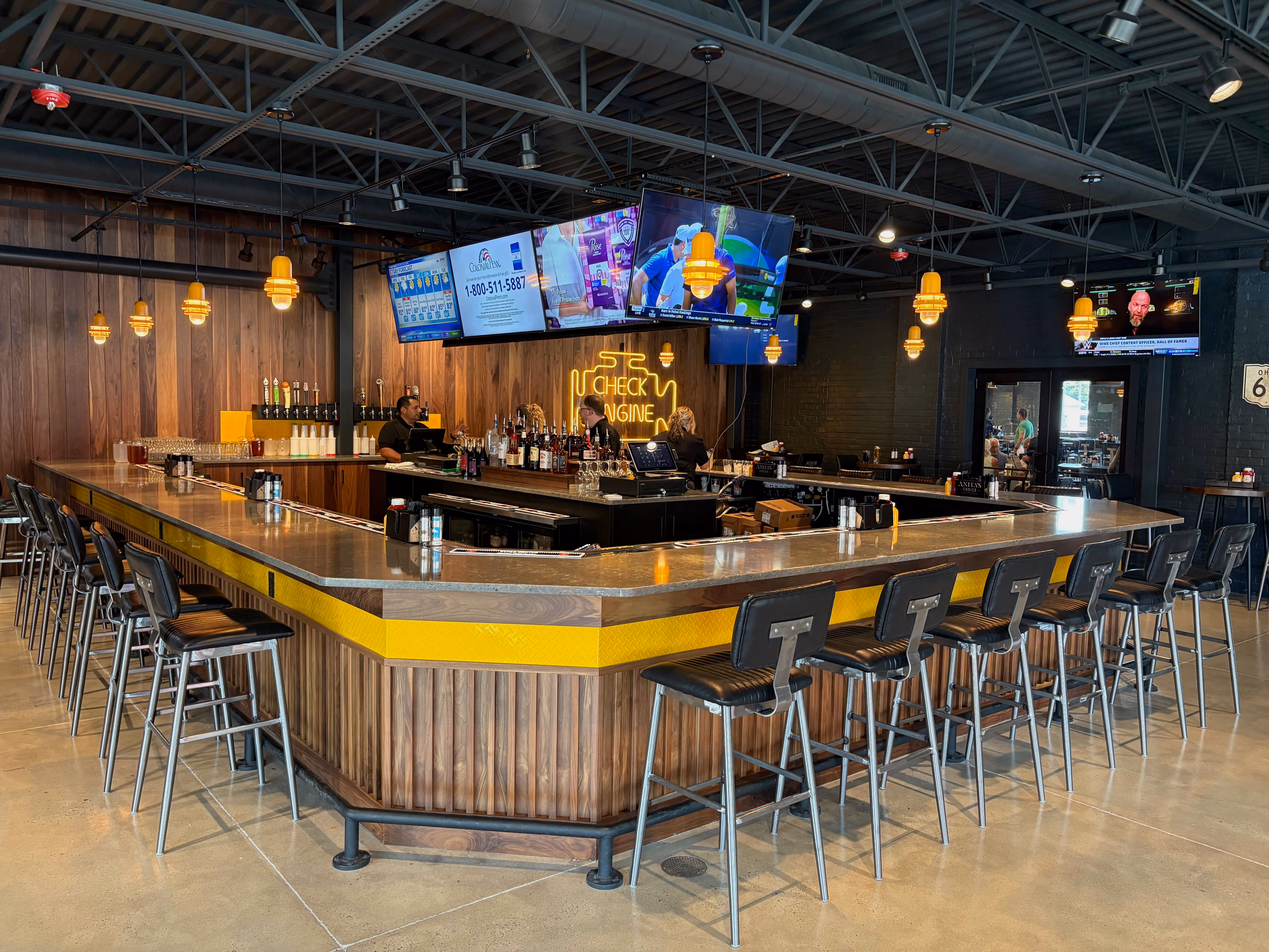Interior of the taproom at Old Route 69 Brewery in Ada, Ohio, featuring a spacious bar, industrial-style decor, polished wood finishes, and a welcoming atmosphere for enjoying craft beer.