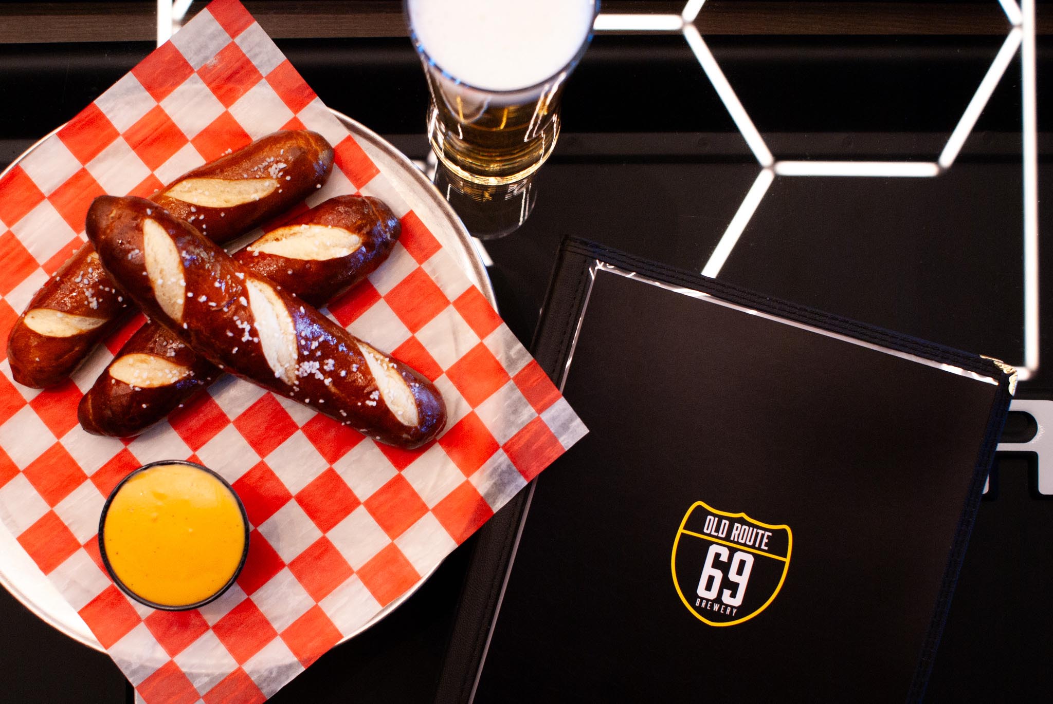 Pretzel sticks, a pint of beer and a menu cover