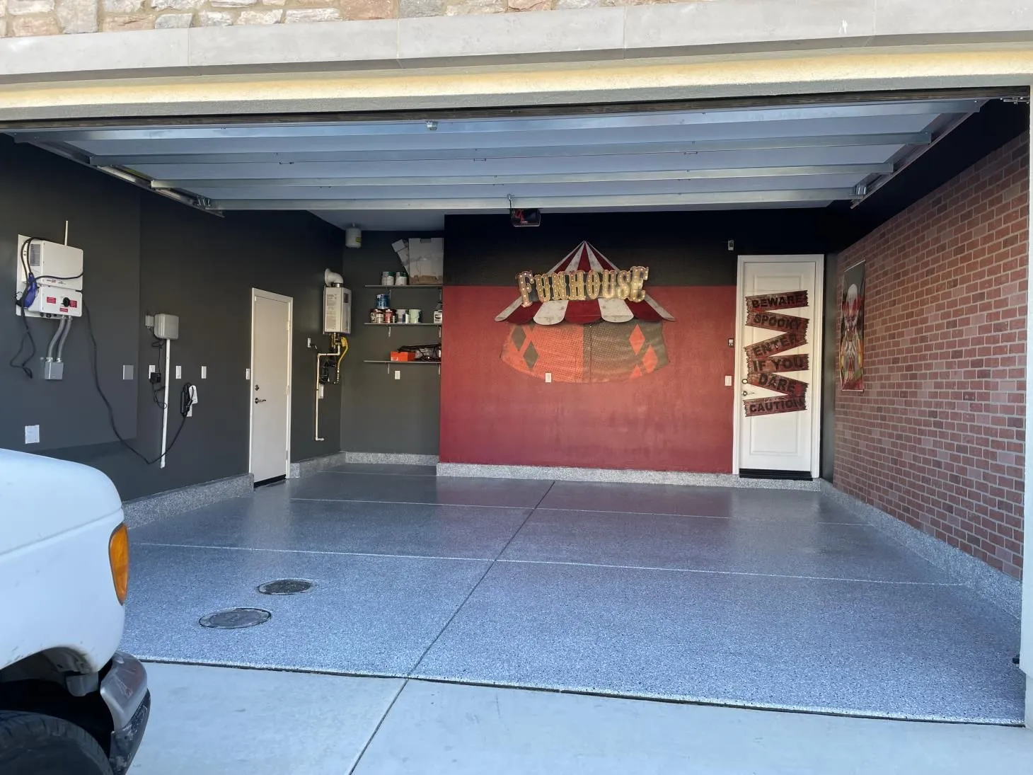 Wide garage floor coated in one unbroken run of flake epoxy by Epoxy Surface Professionals