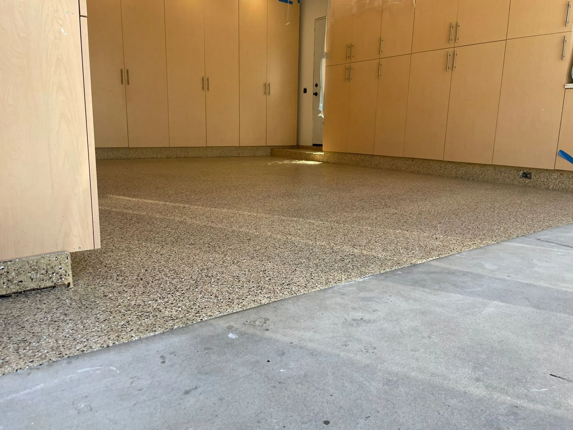 Flake epoxy garage floor running back to the door into the house by Epoxy Surface Professionals