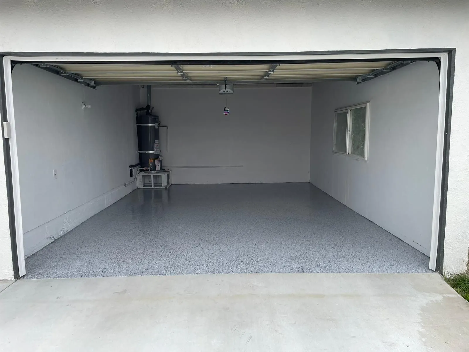 Two-car garage bay finished in flake epoxy, seen square on from the driveway by Epoxy Surface Professionals