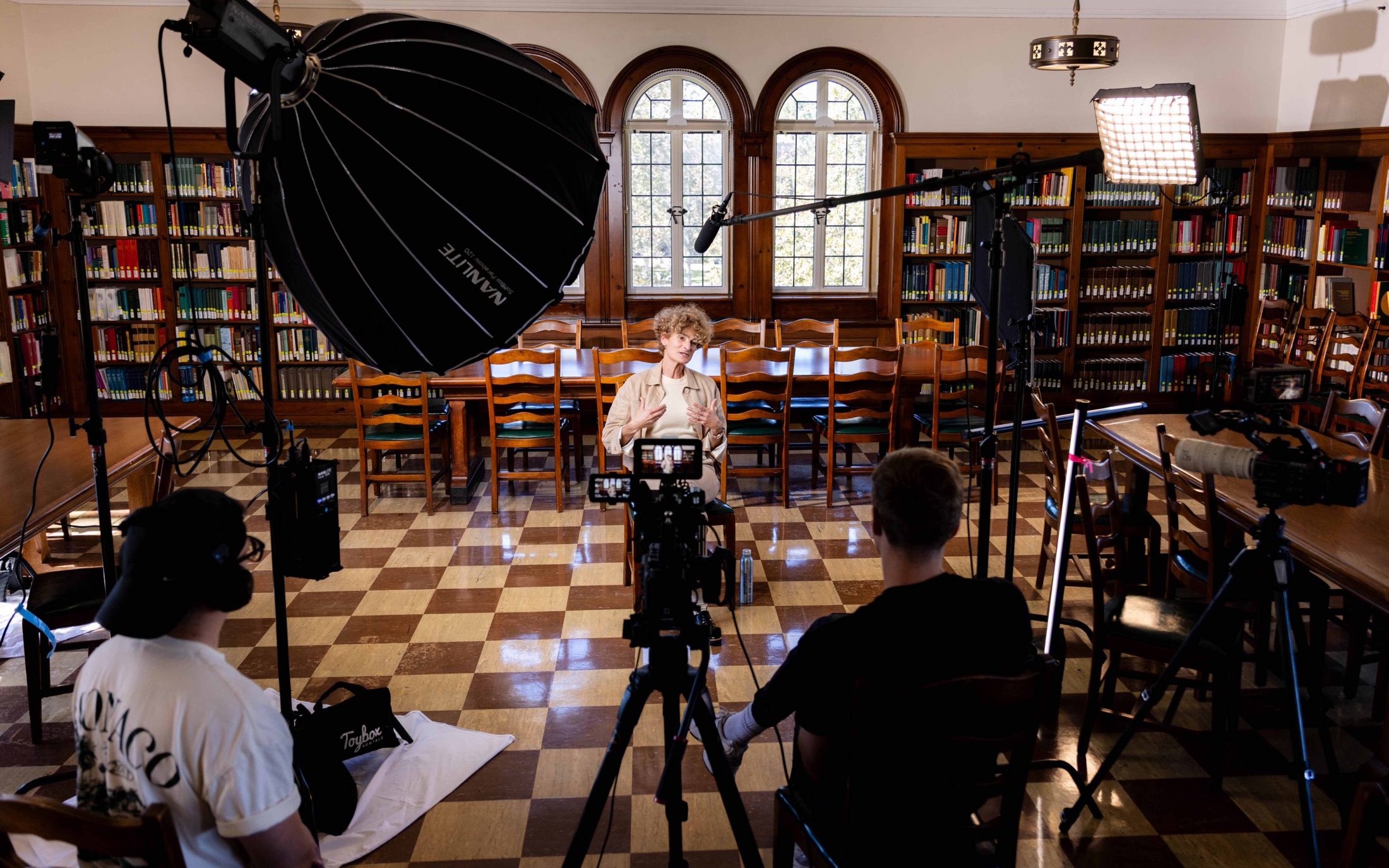 A McGill Productions crew filming an online learning module with a presenter in a university library