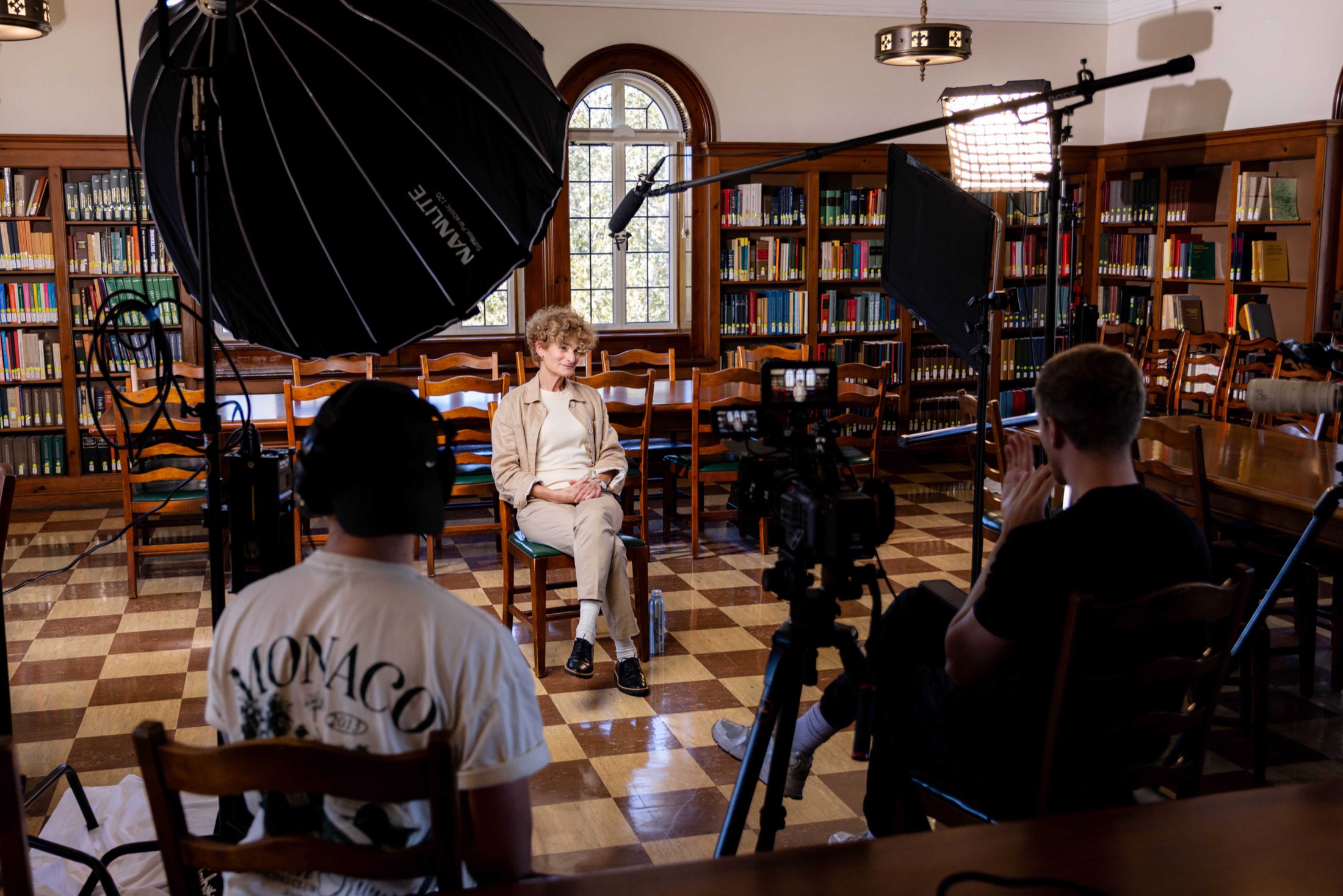 A McGill Productions crew filming an online learning module with a presenter in a university library