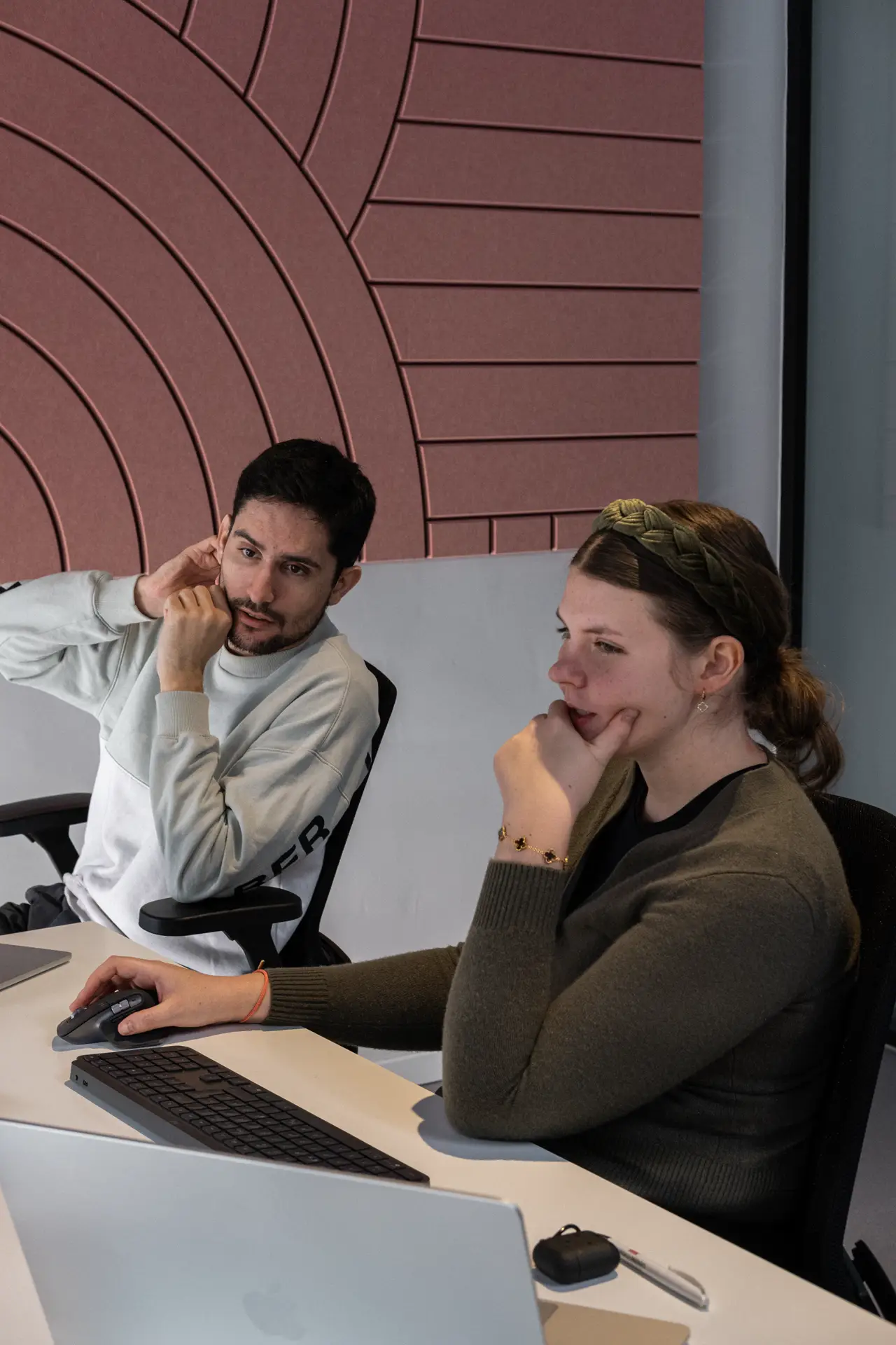 Two people talking closely while seated at a table.