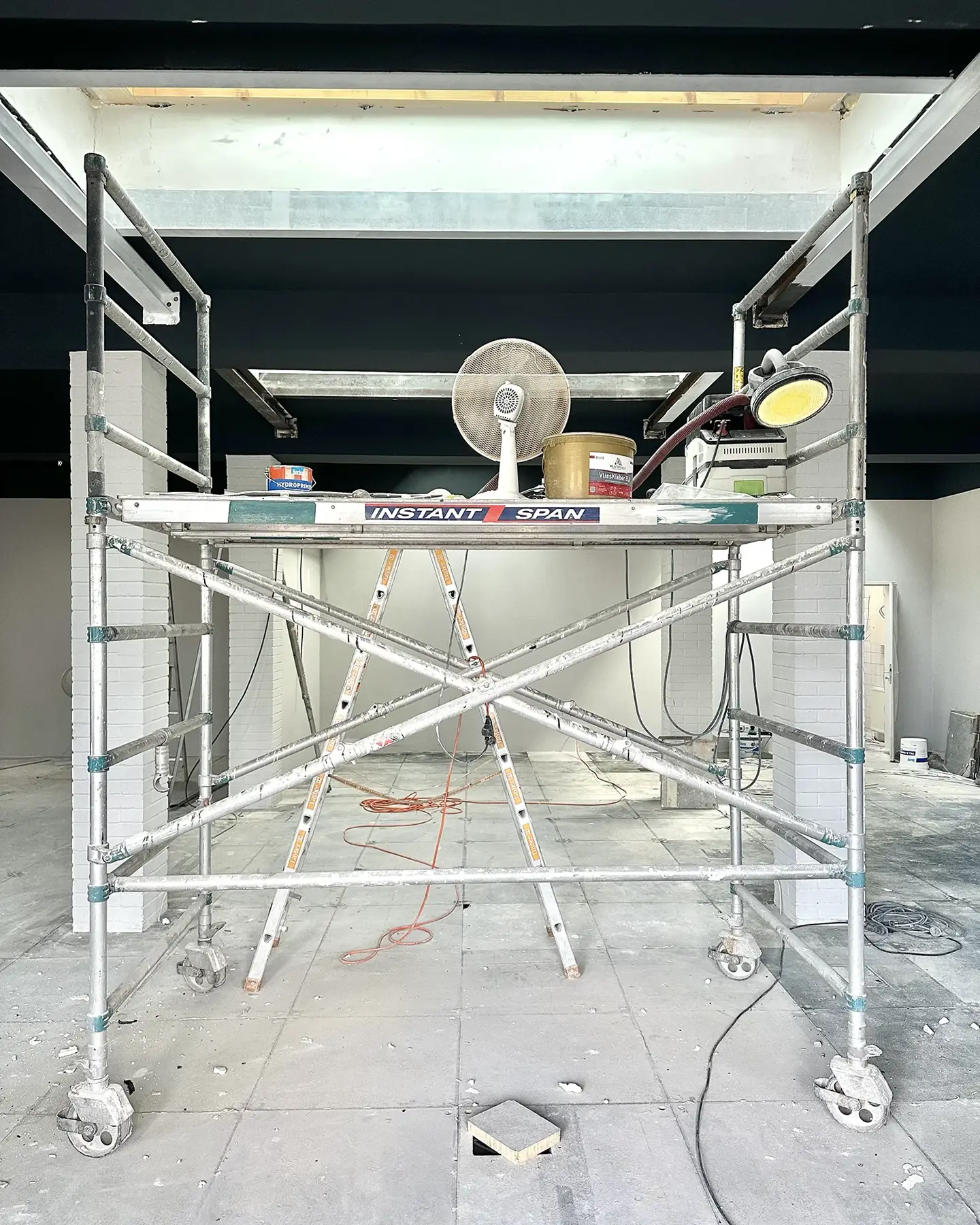 A construction ladder inside an office during ongoing renovations.