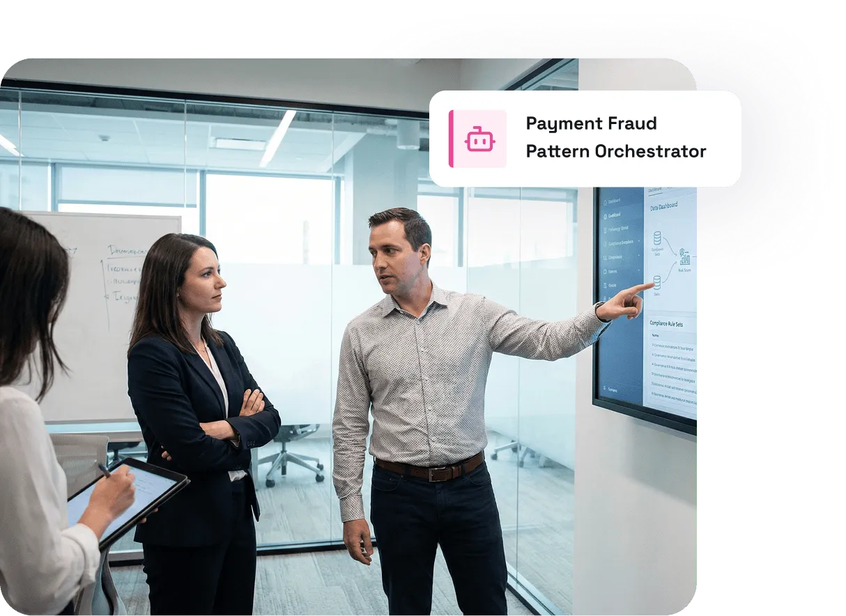 Man presenting data on a screen to two attentive colleagues in a modern office meeting room.