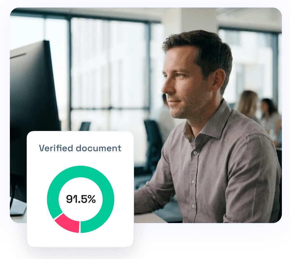 Man sitting at a desk working on a computer with a graphic showing 91.5% verified document in the foreground.