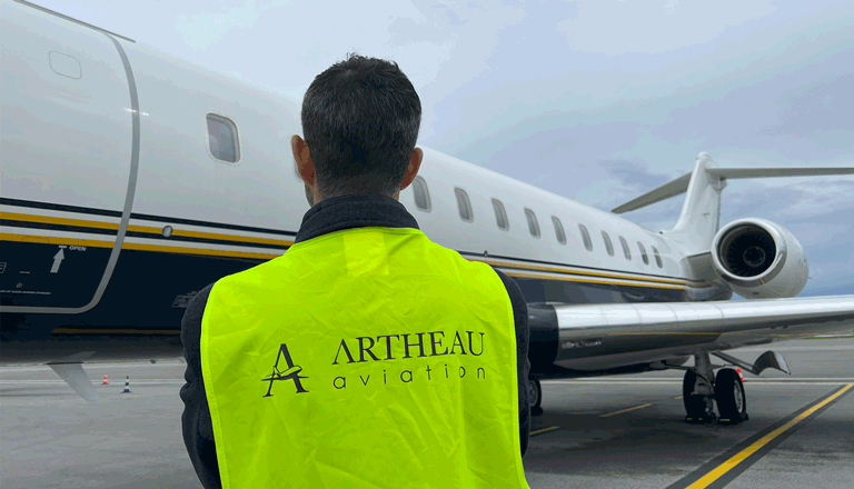 A Artheau Aviation broker front of private jet