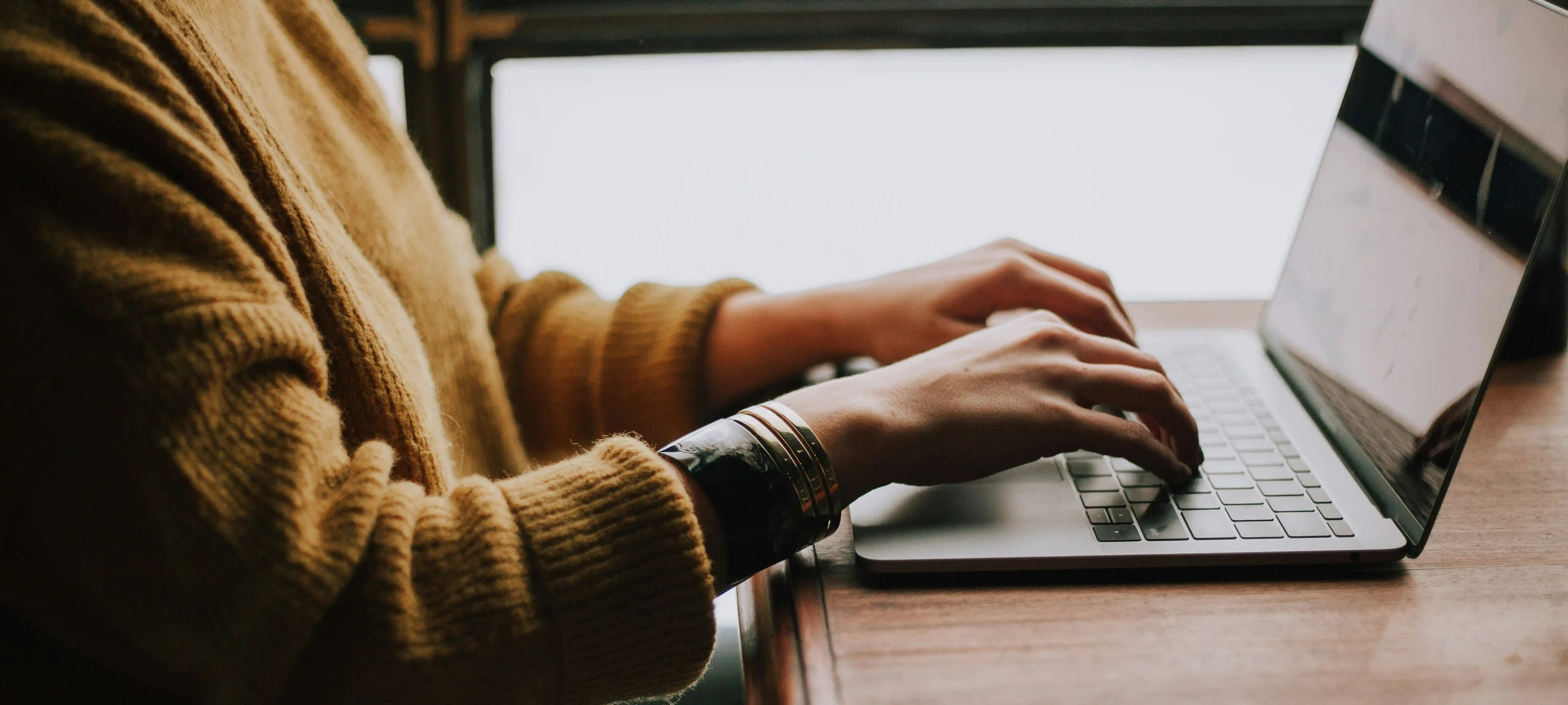 Person tippt an einem Laptop für Hotelkampagnen