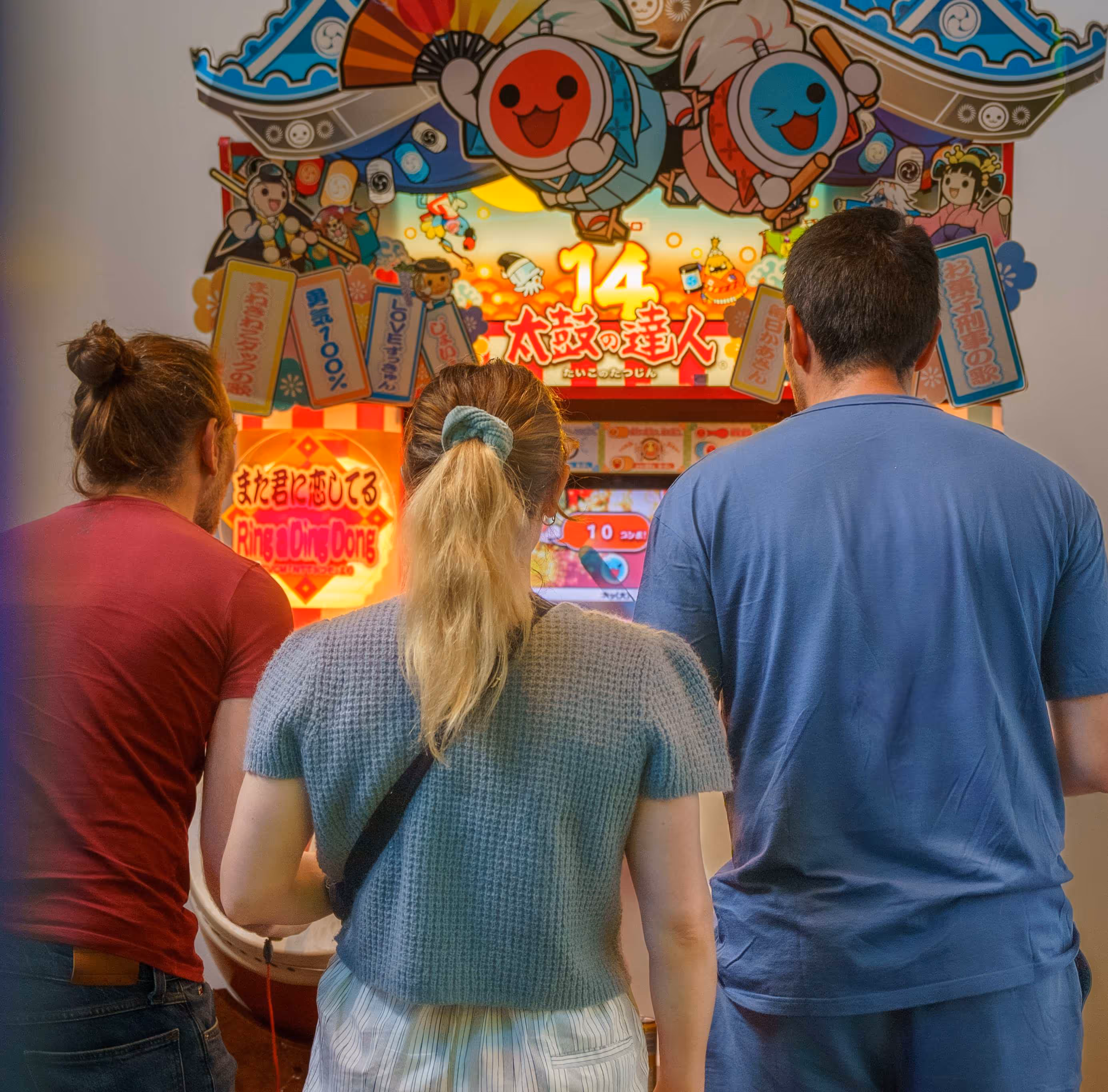 3 persons playing a retro video game