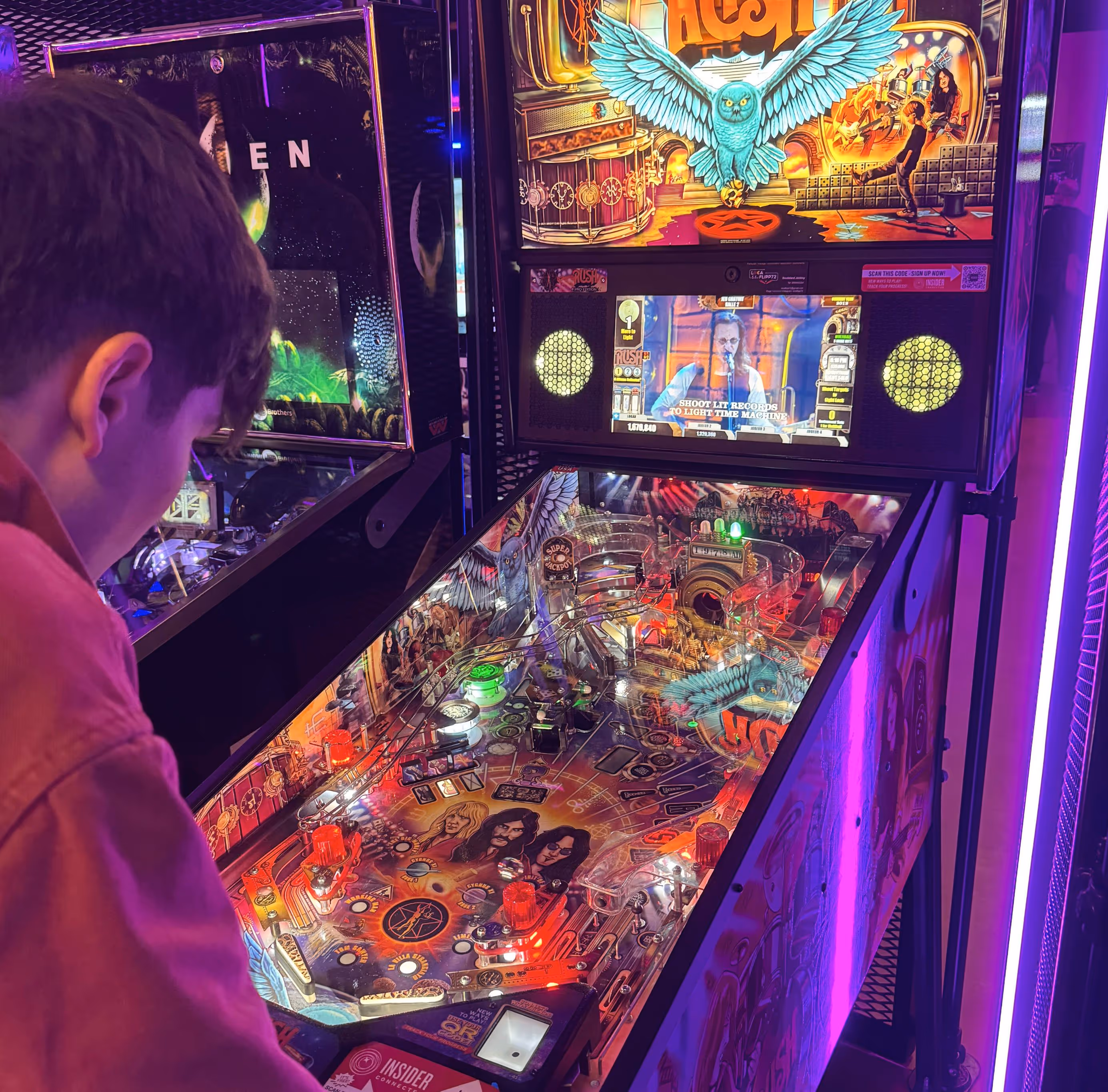 kid playing pinball