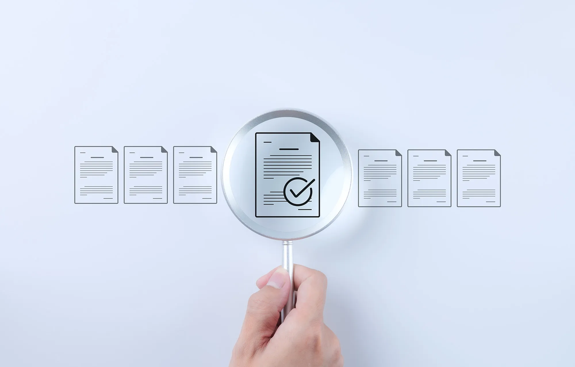 a hand holding a lens to audit data