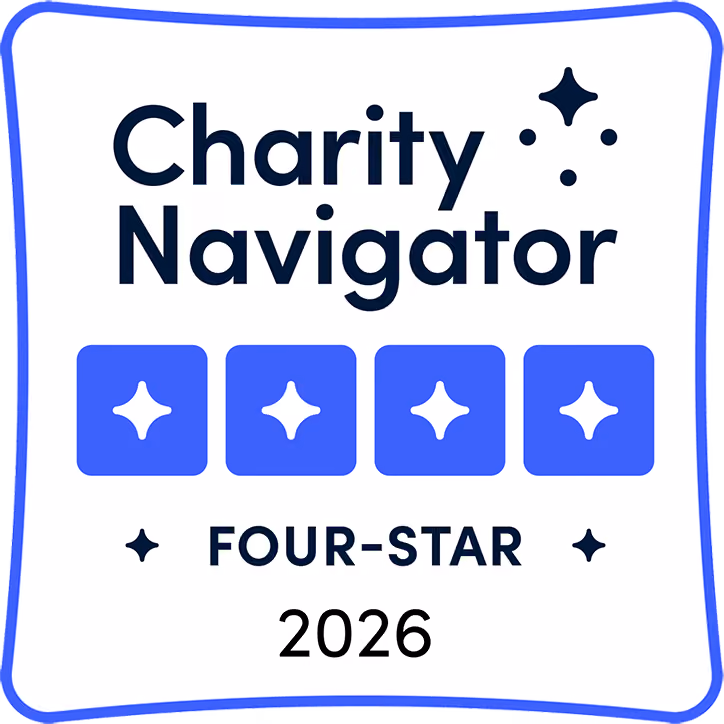 Charity Navigator four-star rating badge for 2026 with four blue stars and decorative elements.