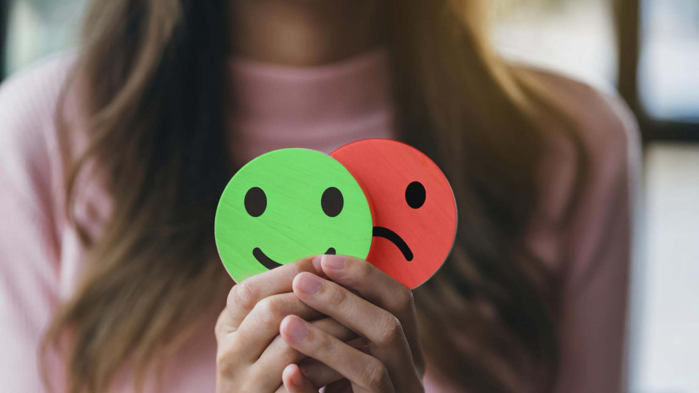 Person showing both happy and sad expressions, representing bipolar diagnosis in Denver, CO