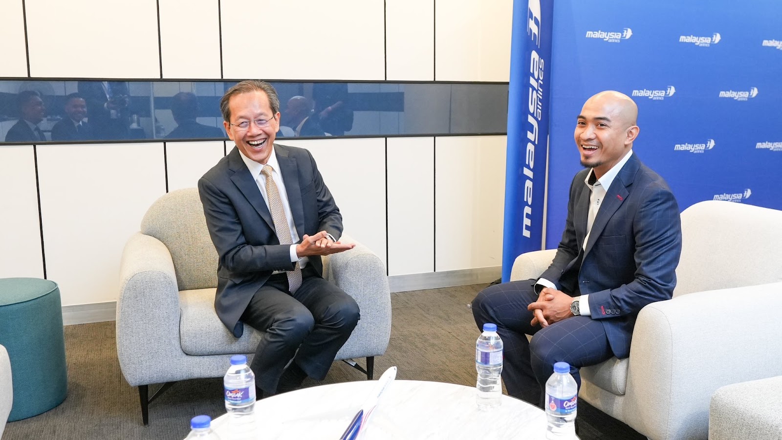Dato’ Azizulhasni Awang; and Datuk Captain Izham Ismail, Group Managing Director of MAG sitting on the sofa smiling