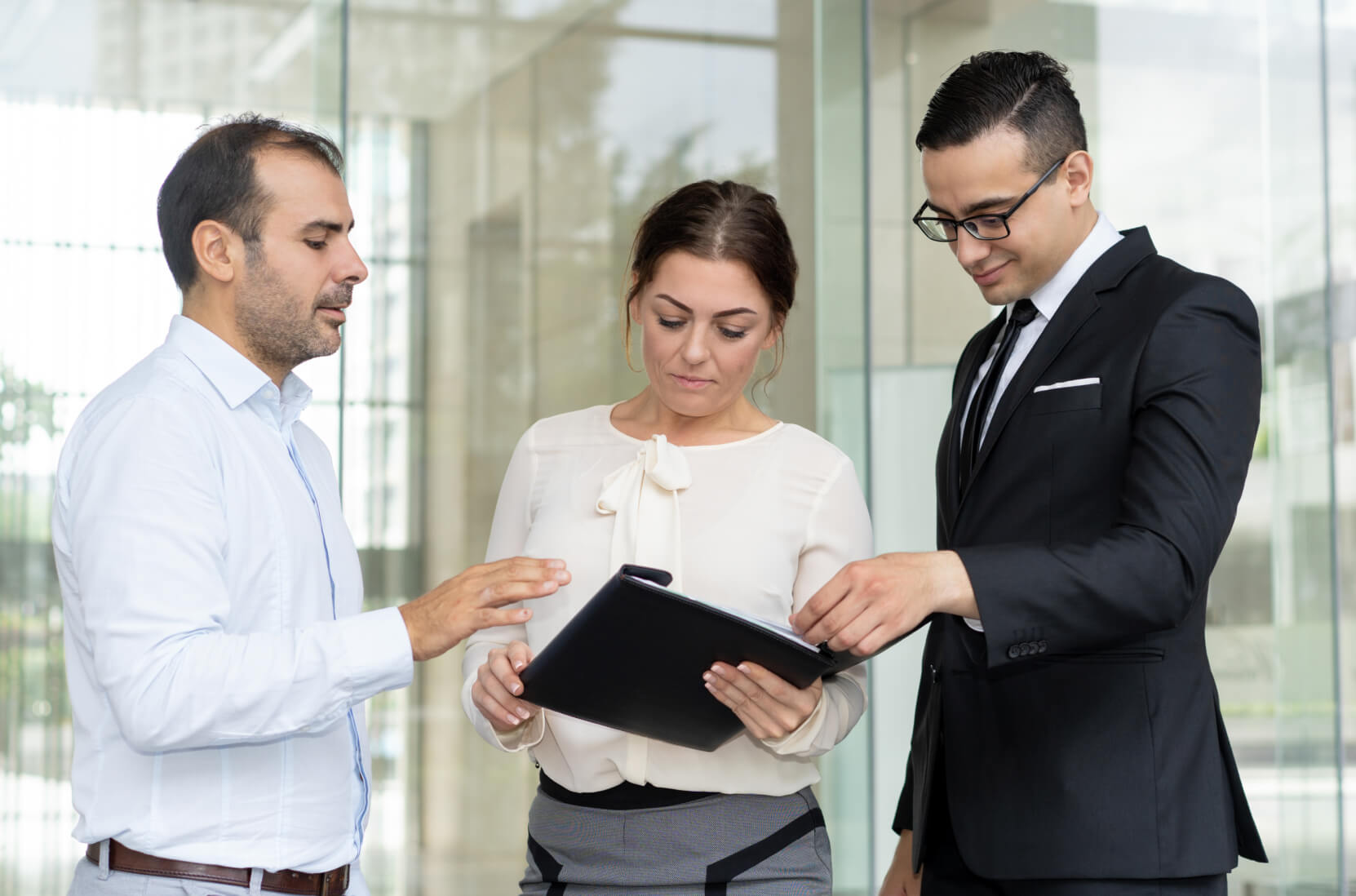 A man and a woman looking at something on a clipboard.