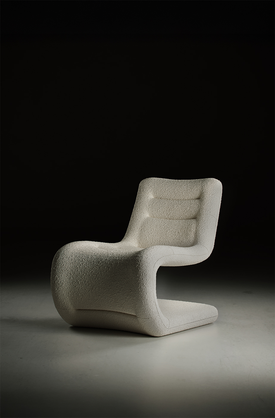 Modern sculptural lounge chair with boucle fabric and ergonomic curved design — minimalist designer armchair for contemporary interiors