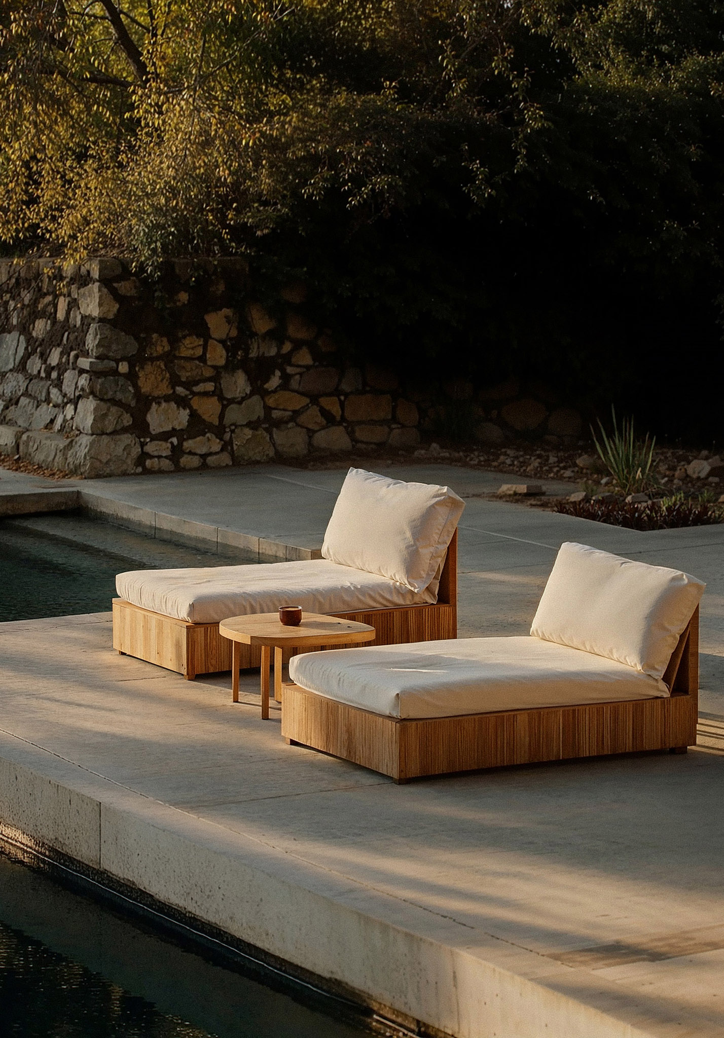 Modern outdoor lounge chairs with natural wood base and cream cushions by the poolside — minimalist patio furniture for luxury garden or terrace design