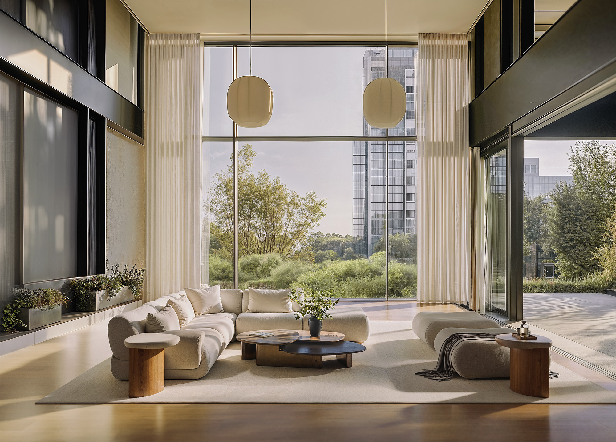 Spacious modern living room with panoramic floor-to-ceiling windows, neutral curved sofa, designer coffee tables and soft natural light — luxury interior design for high-end real estate visualization