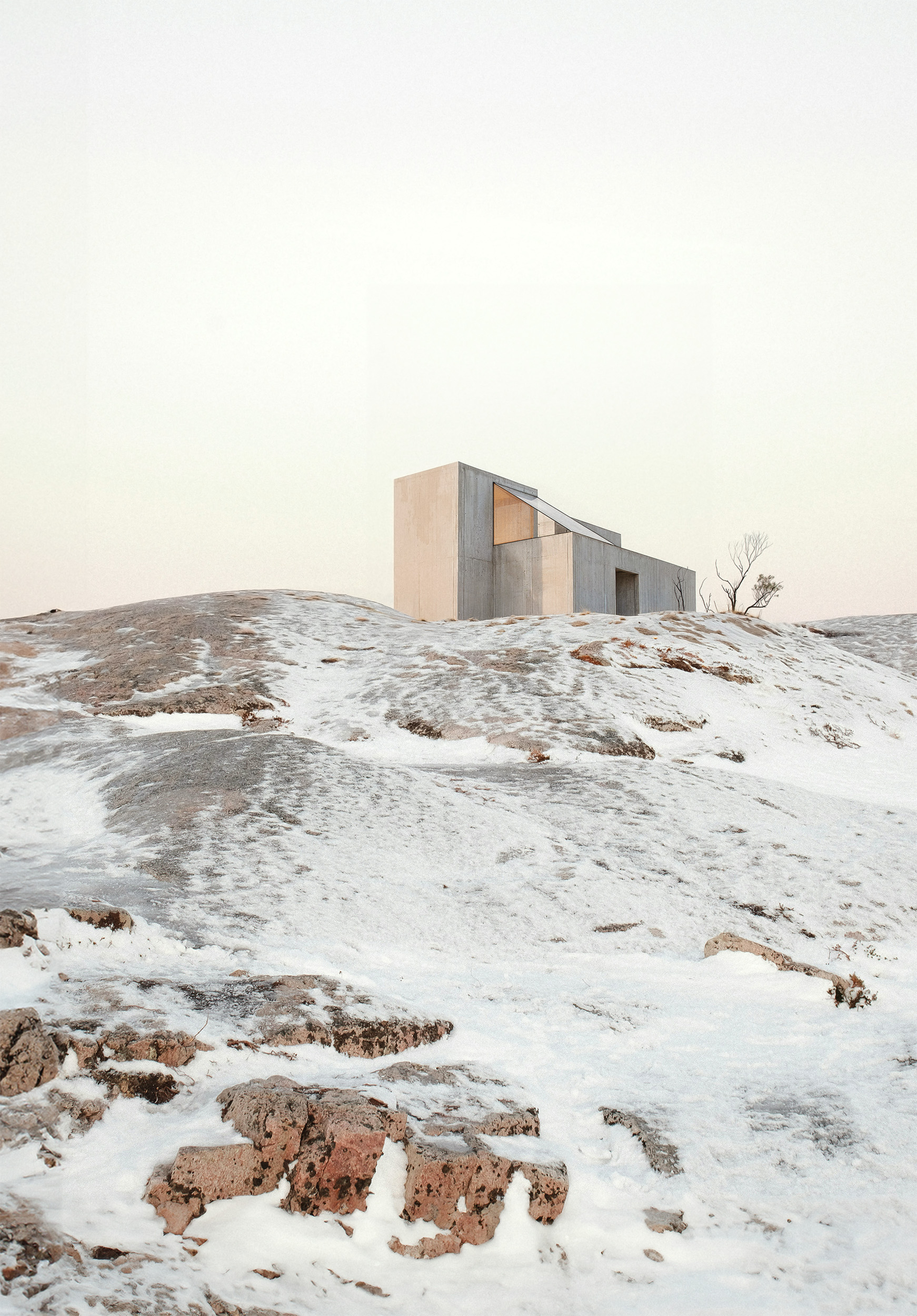 Brutalist concrete cabin in a snowy arctic landscape — minimalist winter architecture with geometric form integrated into frozen rocky terrain