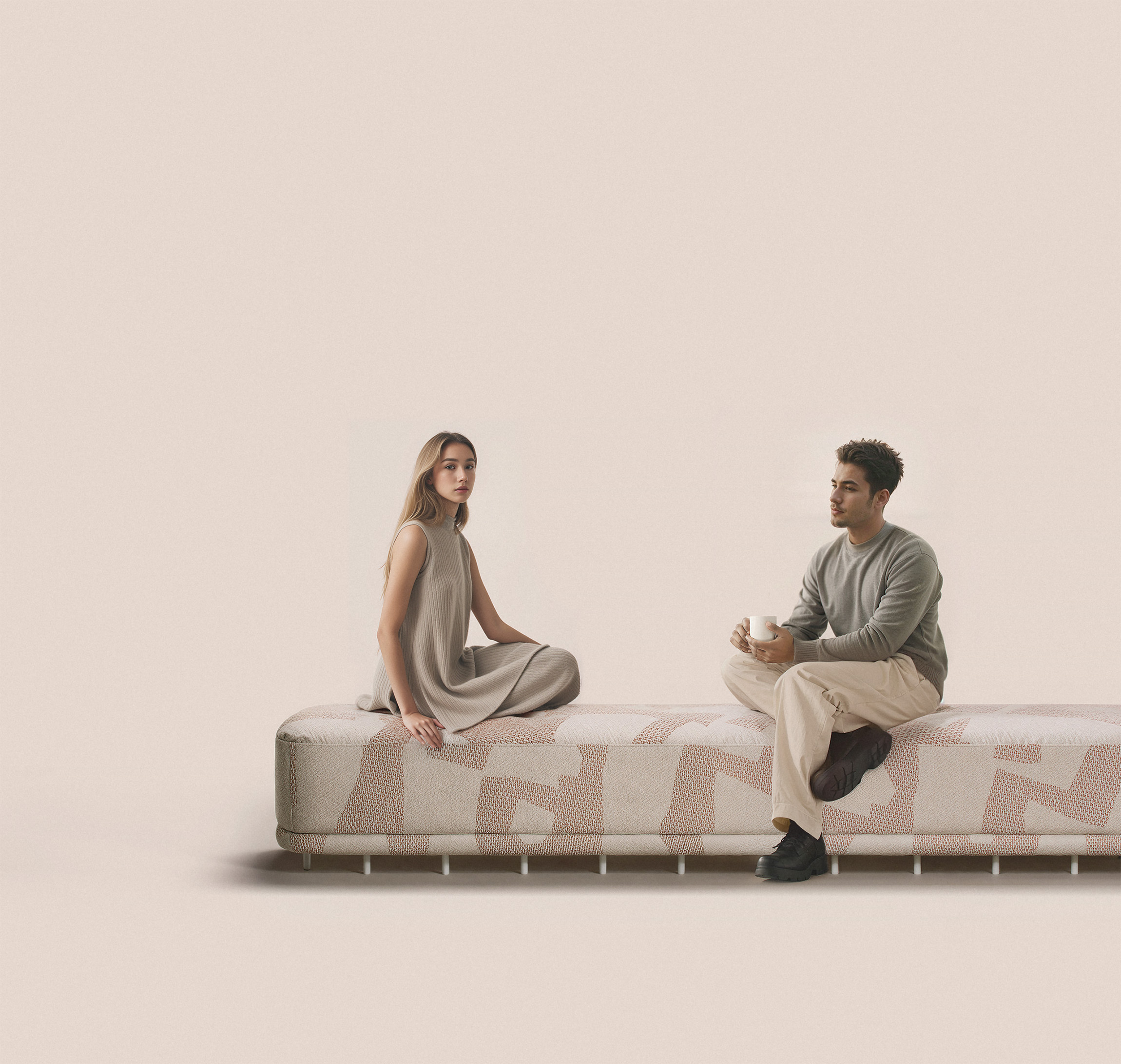 Minimalist fabric bench with abstract upholstery, featuring two people in neutral-toned outfits — modern furniture design with lifestyle context on soft beige background