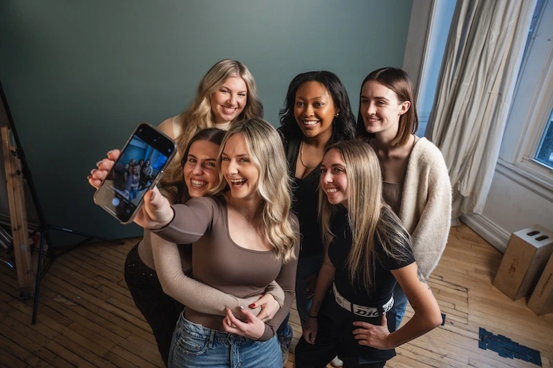 Precision Social media managers team poses for a selfie picture in a photo studio