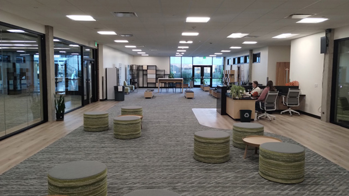 Interior view of open concept office with collaborative seating areas and floor to ceiling windows