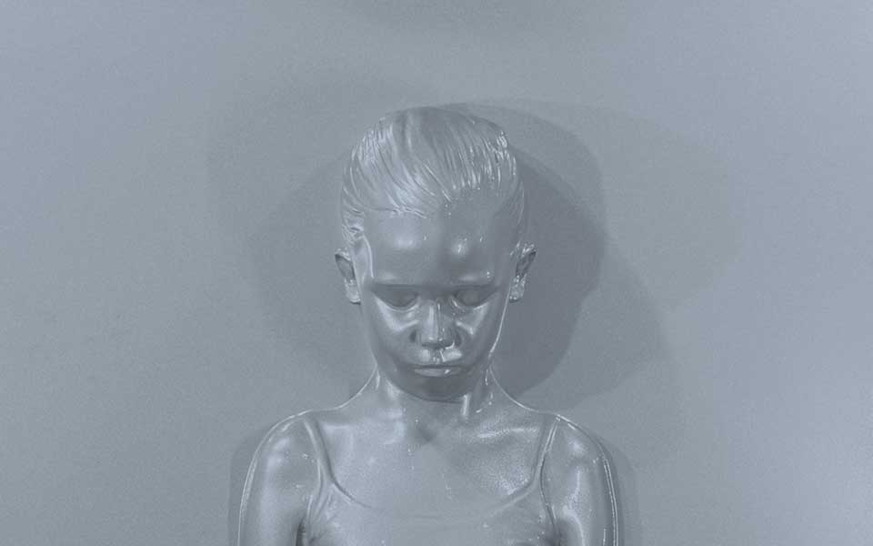 a black and white photo of a plastic doll