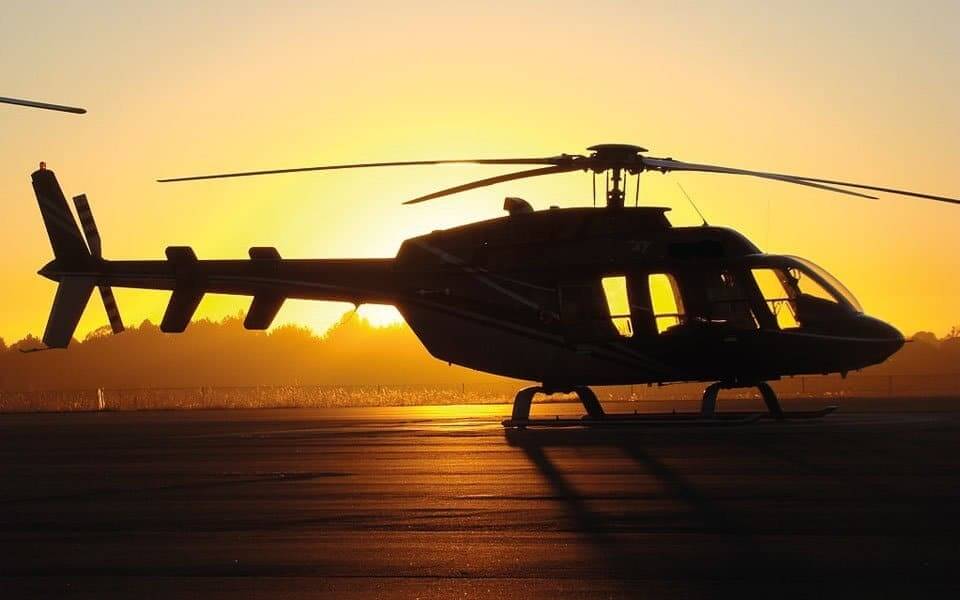 a helicopter sitting on top of an airport tarmac