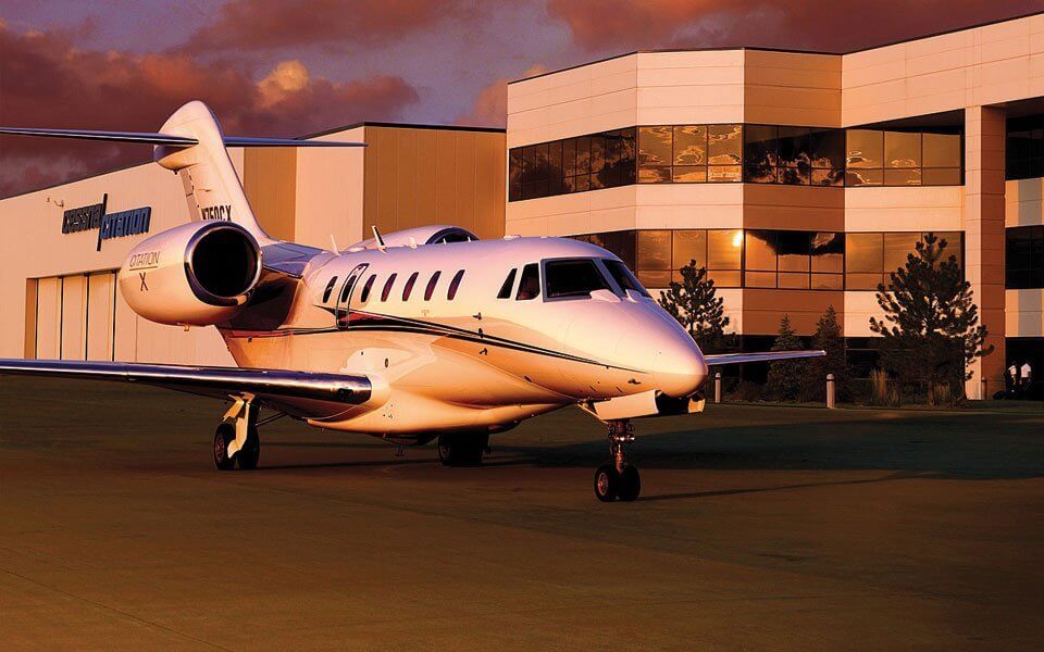 a private jet parked in front of a building