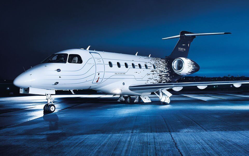a white airplane sitting on top of an airport tarmac